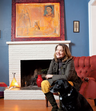 Frances McCue (with pal Ida) fills her home with Moroccan art, such as the large painting by Mohammed Daoudi, and the small henna tree, by Zini