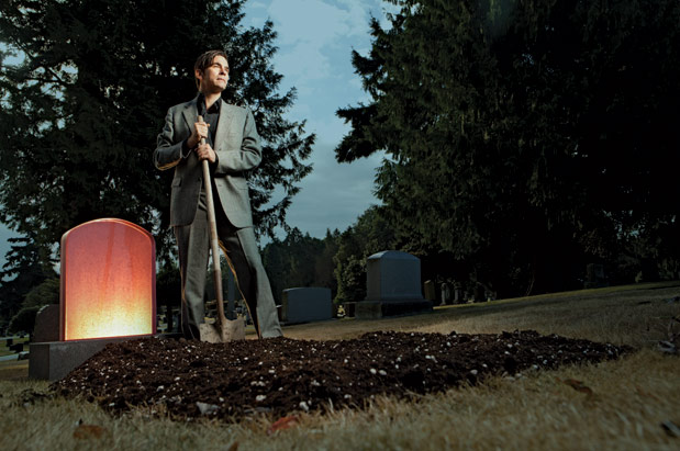 Artist Greg Lundgren believes that changing the way we memorialize death can improve the way we live our lives. He is pictured with one of his cast-glass headstones